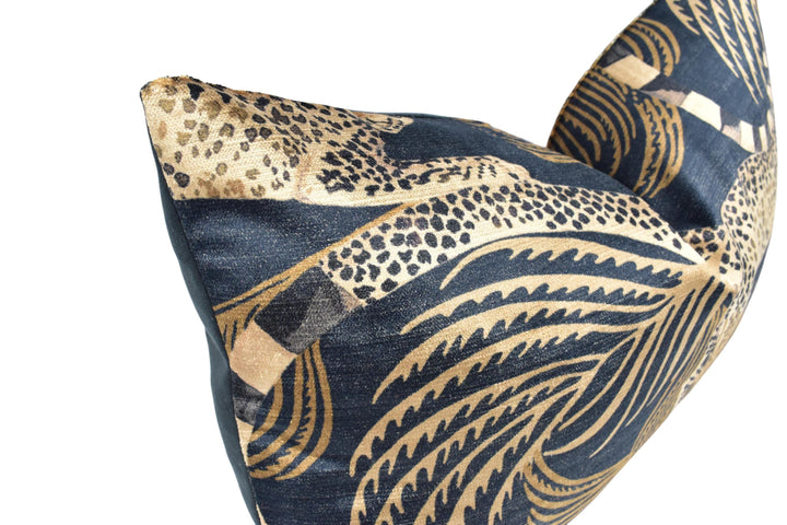 a close-up view of a decorative pillow with a leopard print pattern in shades of blue and gold.