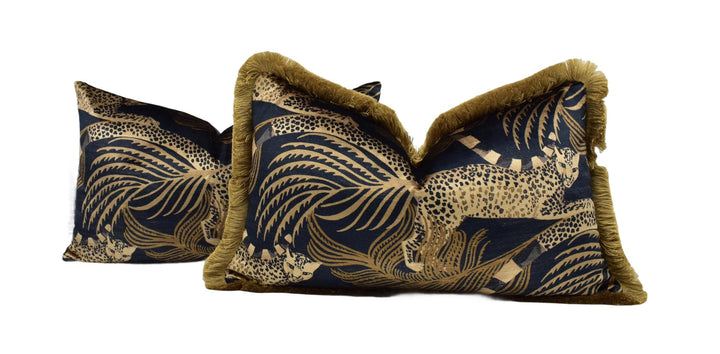 two decorative pillows with a leopard print pattern and gold trim.