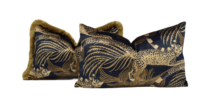 a set of three decorative pillows with a black and gold leopard print design.