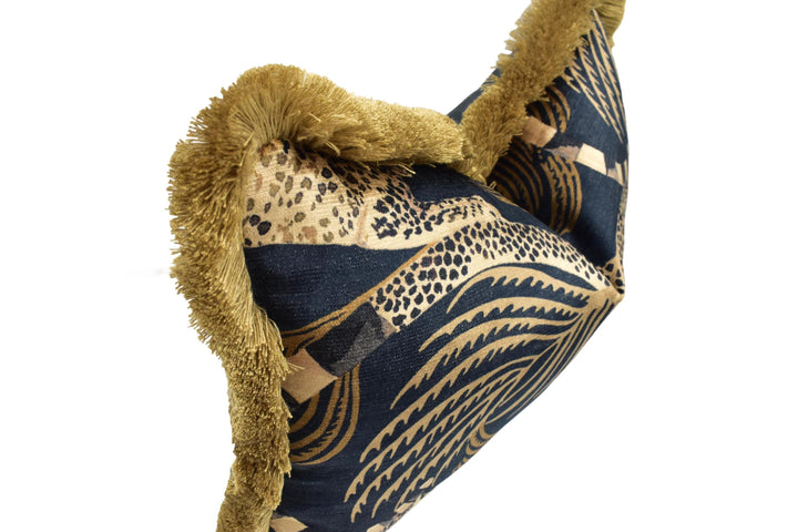 A close-up image of a decorative pillow with a pattern of leopard print and gold accents.