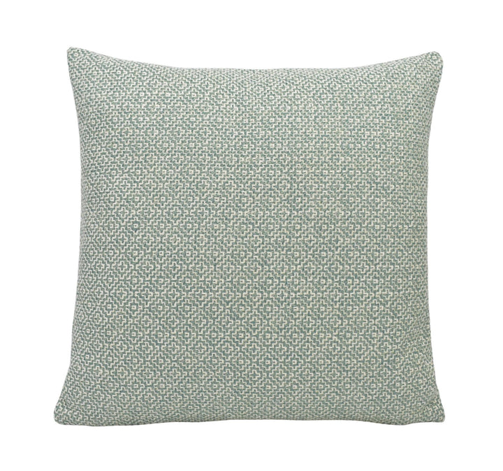 a green and white pillow on a white background