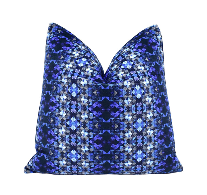 a blue and black pillow on a white background