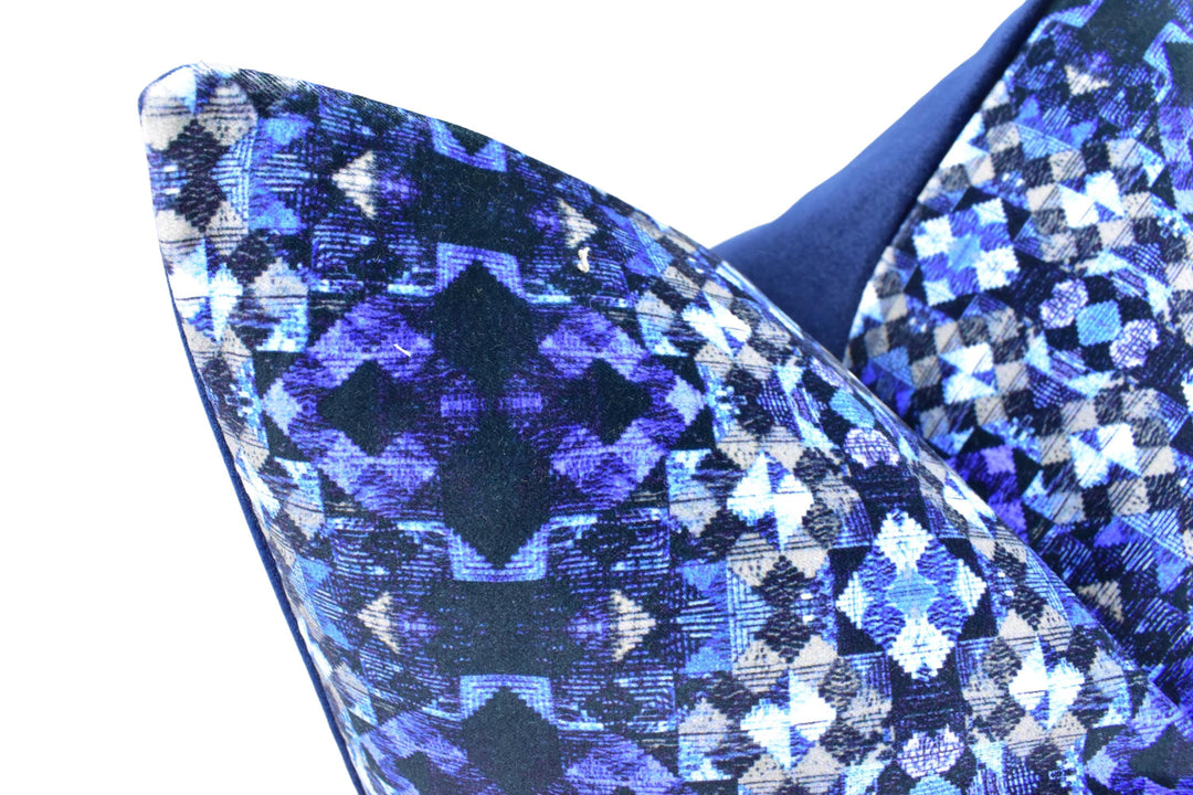 a close up of a blue and black patterned chair