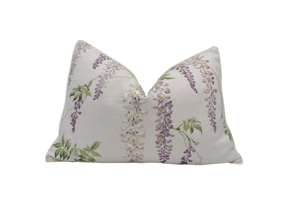 a white pillow with purple flowers on it