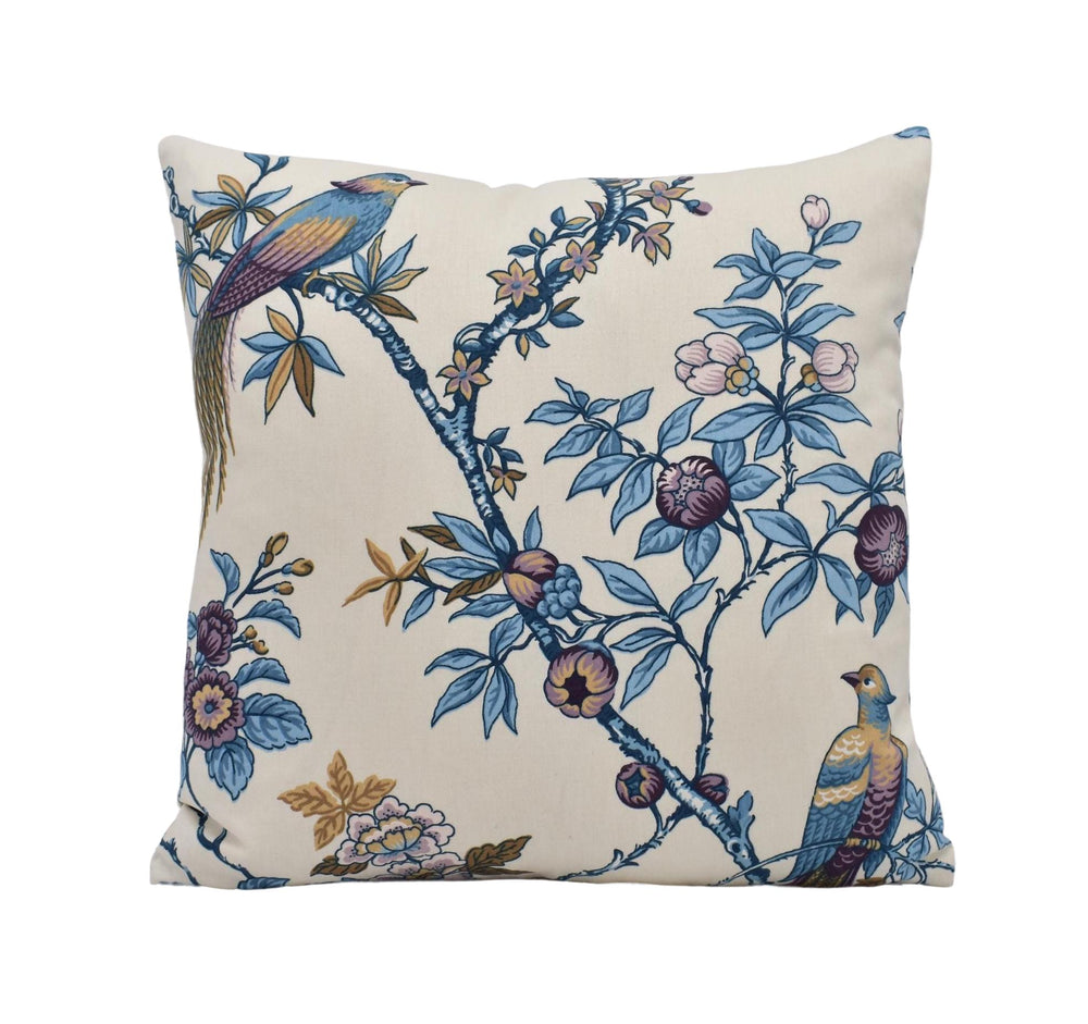 a blue and white pillow with a bird on it