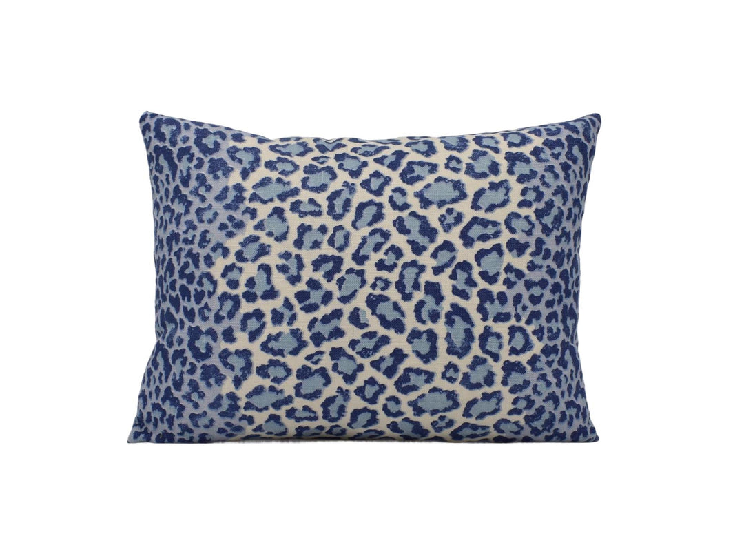 a blue and white leopard print pillow on a white background
