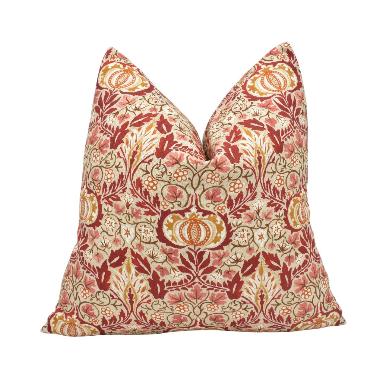 a red and beige pillow with a floral pattern