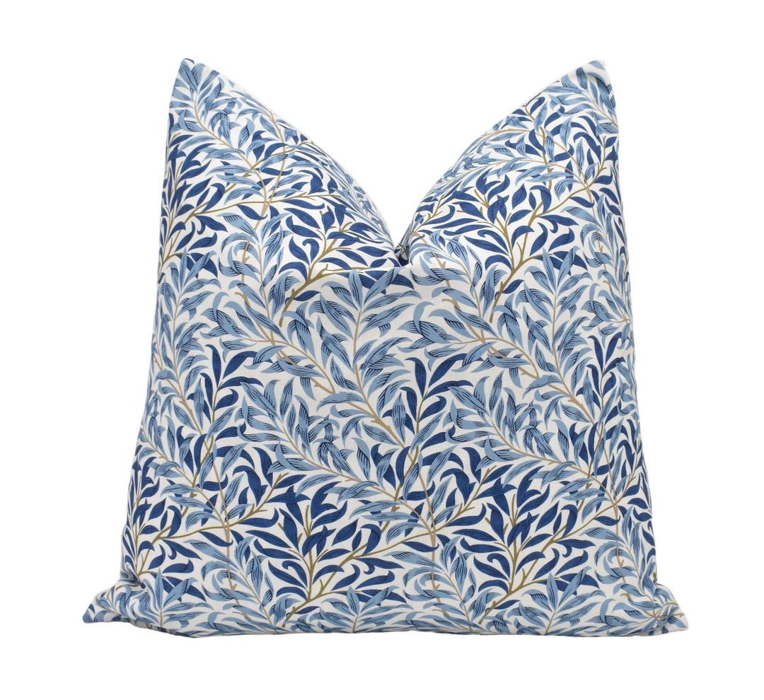 a blue and white pillow on a white background