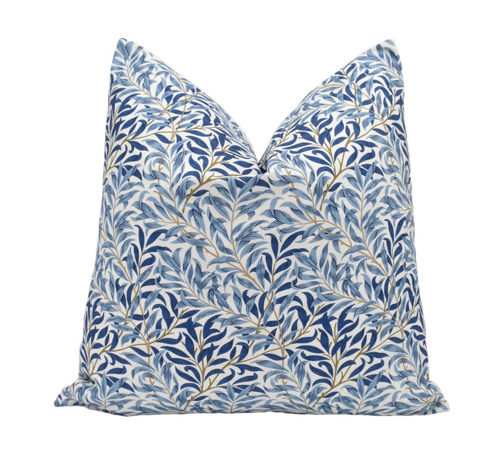 a blue and white pillow on a white background
