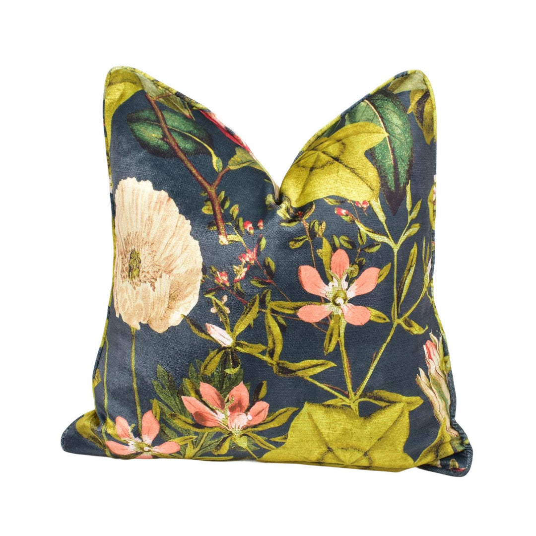 a blue and yellow floral pillow on a white background
