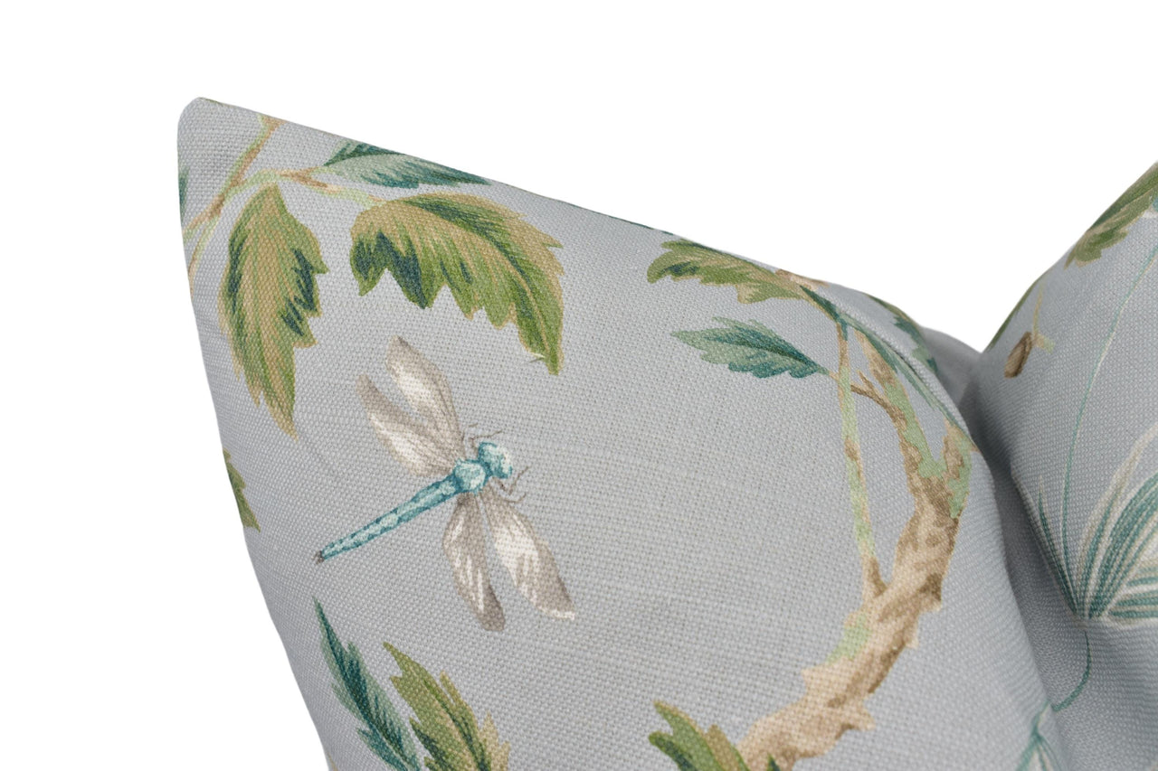 a close up of a pillow with a dragonfly on it