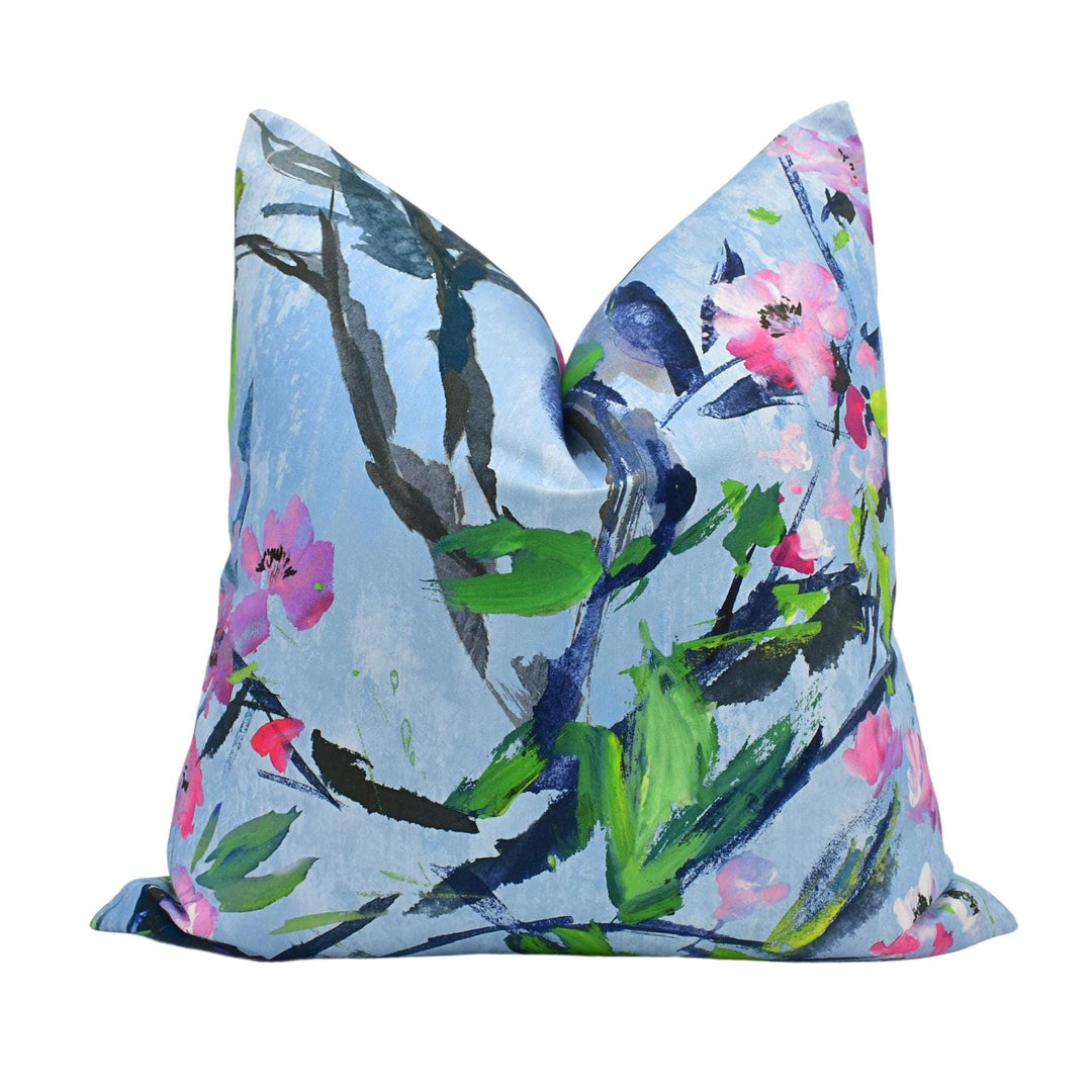 a blue pillow with pink flowers on it