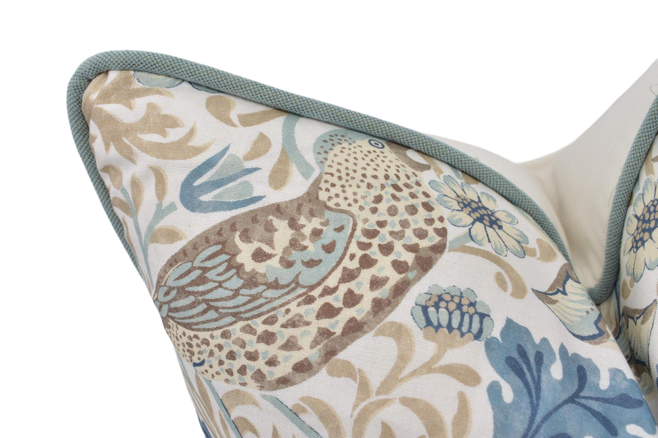 a close up of a pillow with a bird on it