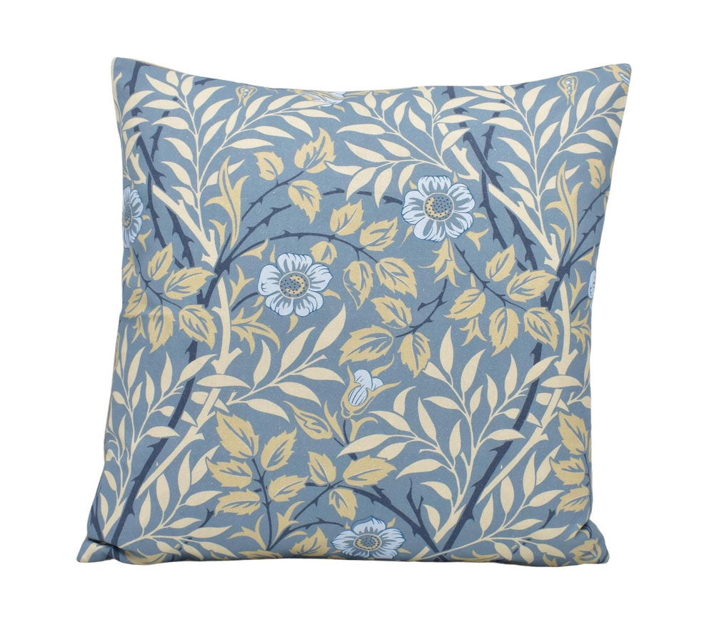 a blue and yellow pillow with flowers on it