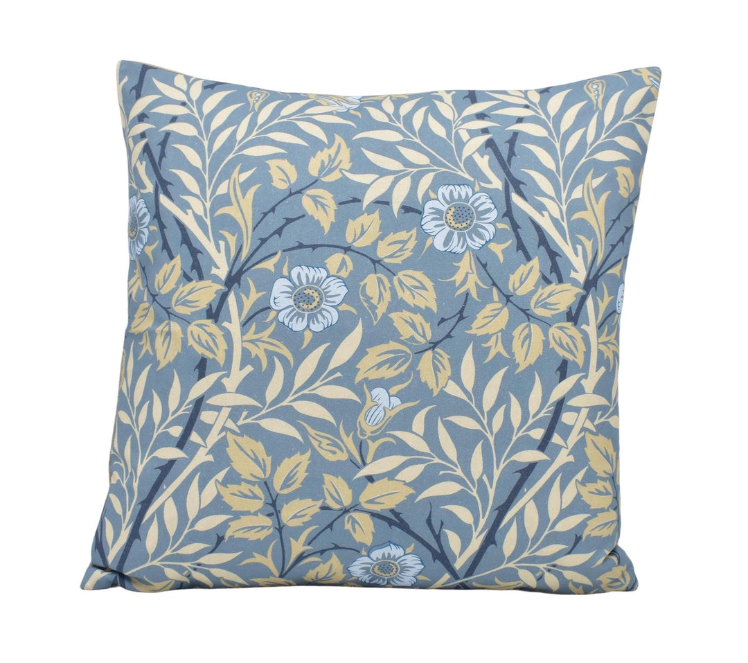 a blue and yellow pillow with flowers on it