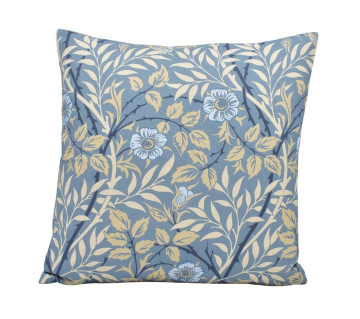 a blue and yellow pillow with flowers on it