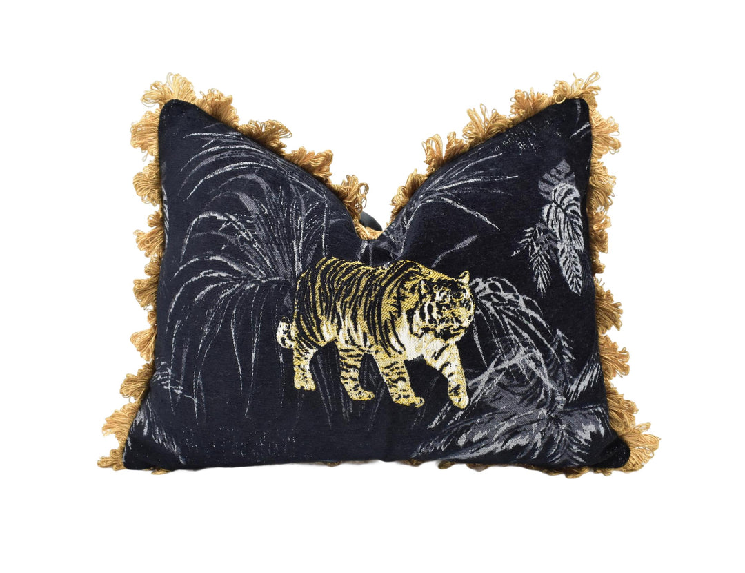 A decorative pillow with a black background and gold trim, featuring a tiger embroidered on it.