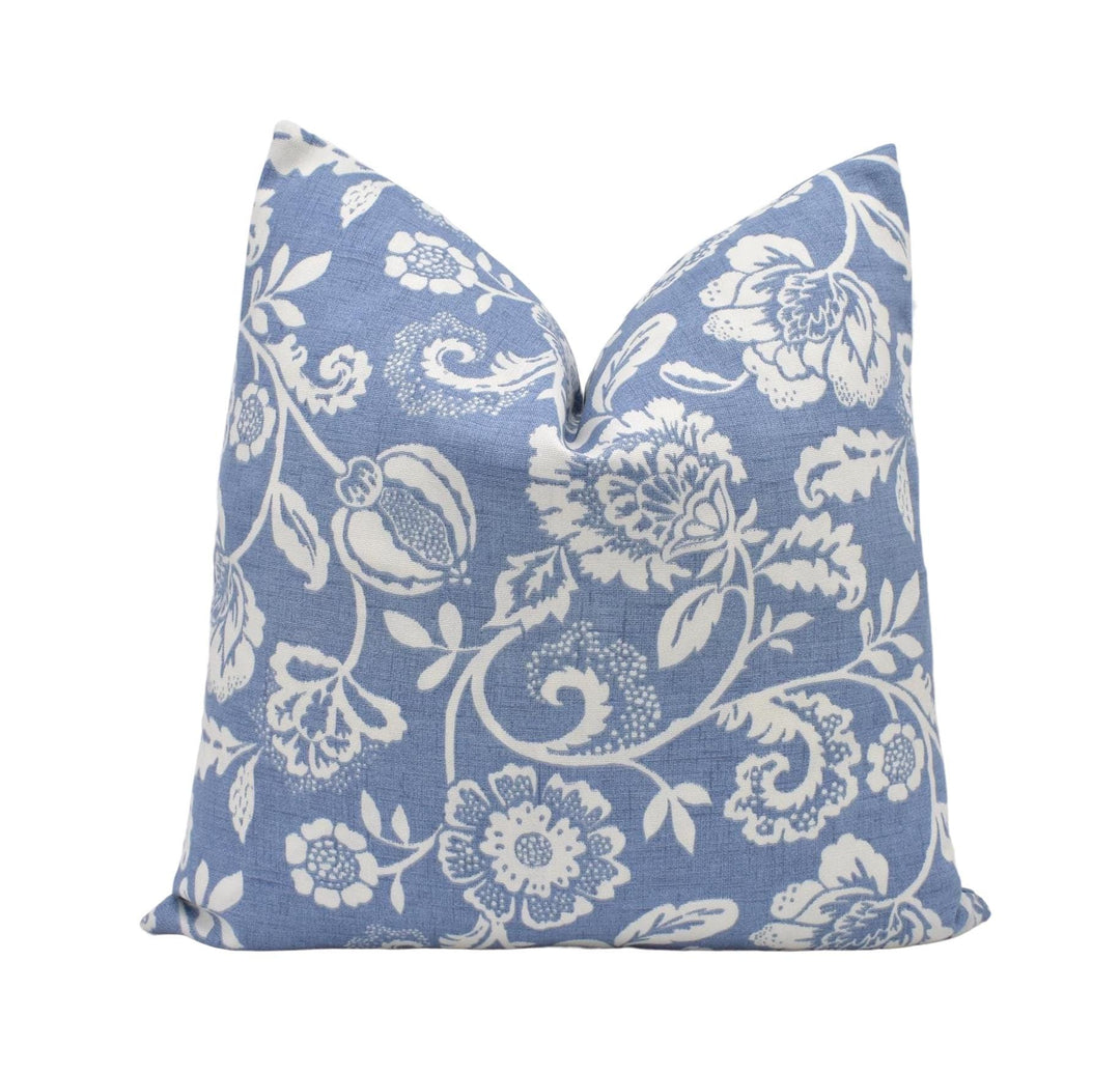 a blue pillow with white flowers on it