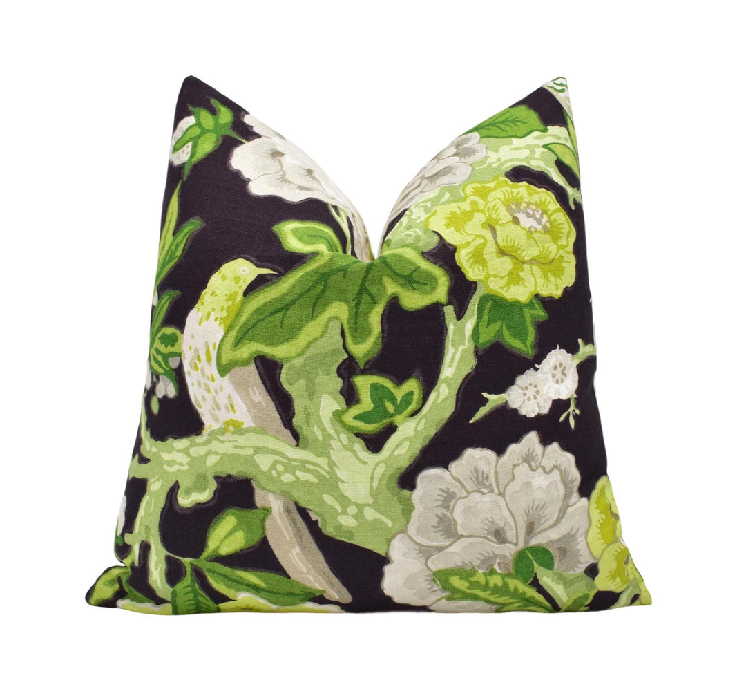 a black and green pillow with white and yellow flowers