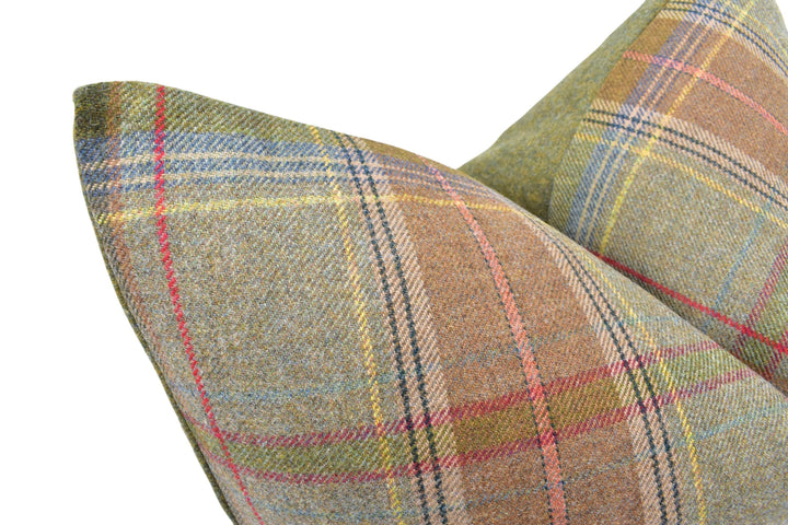 A close-up image of a plaid pillow with a vibrant, multicolored pattern.