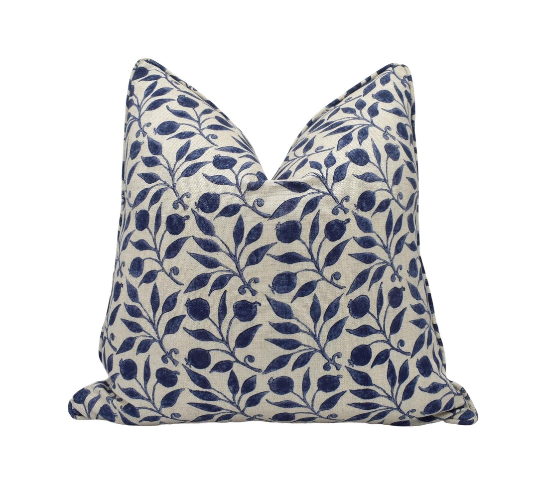 a blue and white pillow on a white background