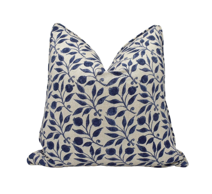 a blue and white pillow on a white background