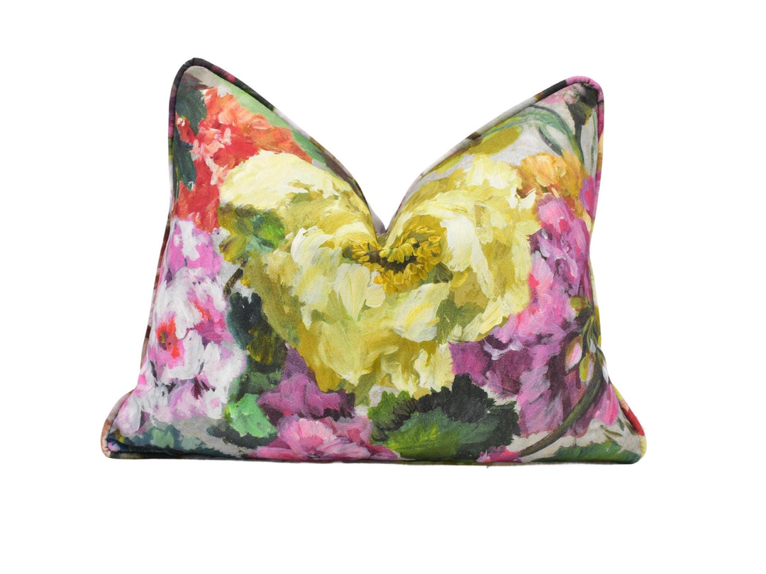 a colorful floral pillow on a white background