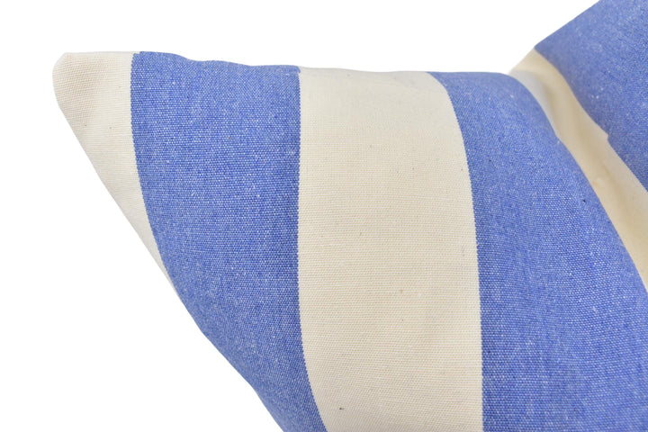 a blue and white striped pillow on a white background