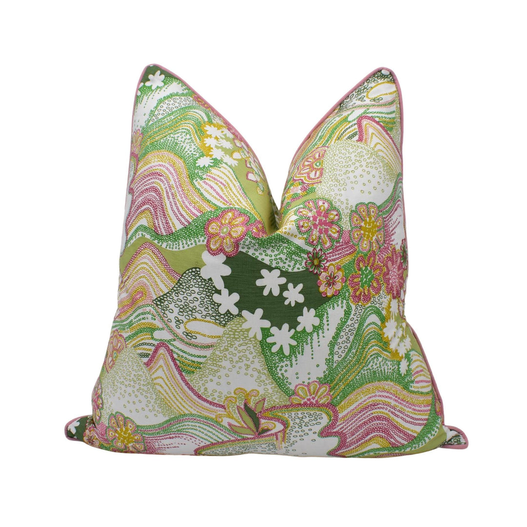 a green and pink pillow with flowers on it