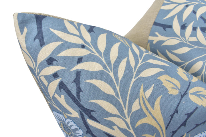 a close up of a blue and yellow pillow on a chair