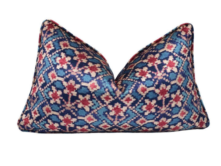 a blue and red pillow on a white background