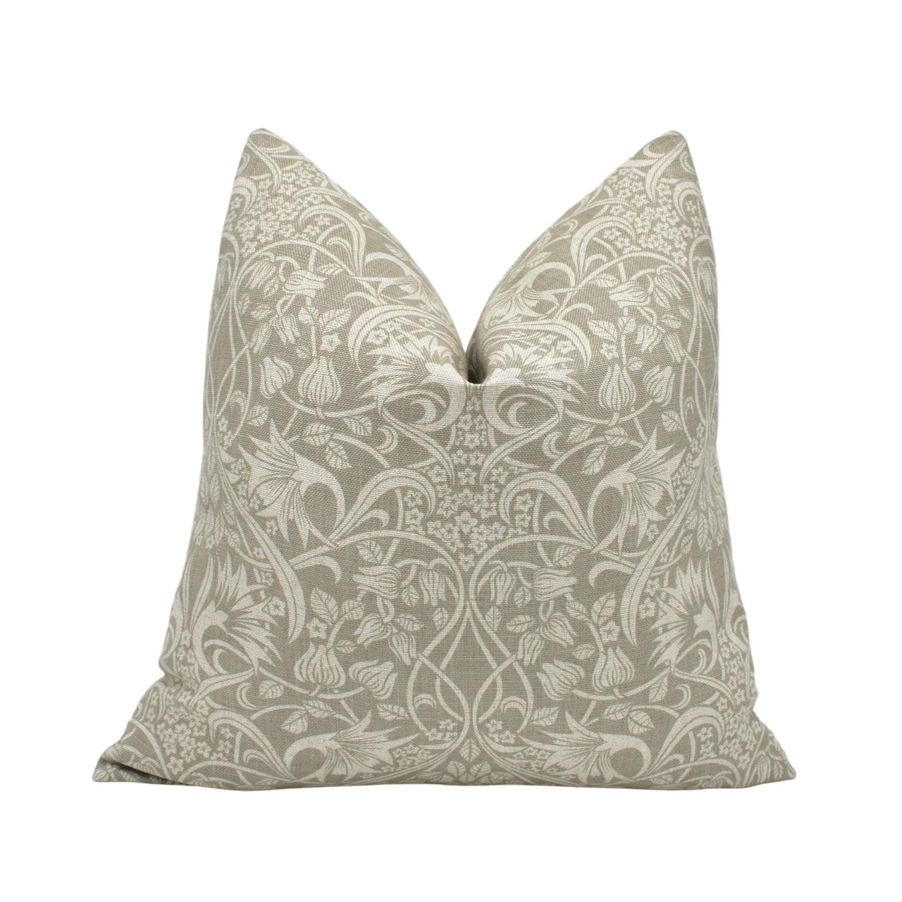 a white and beige pillow with a floral pattern