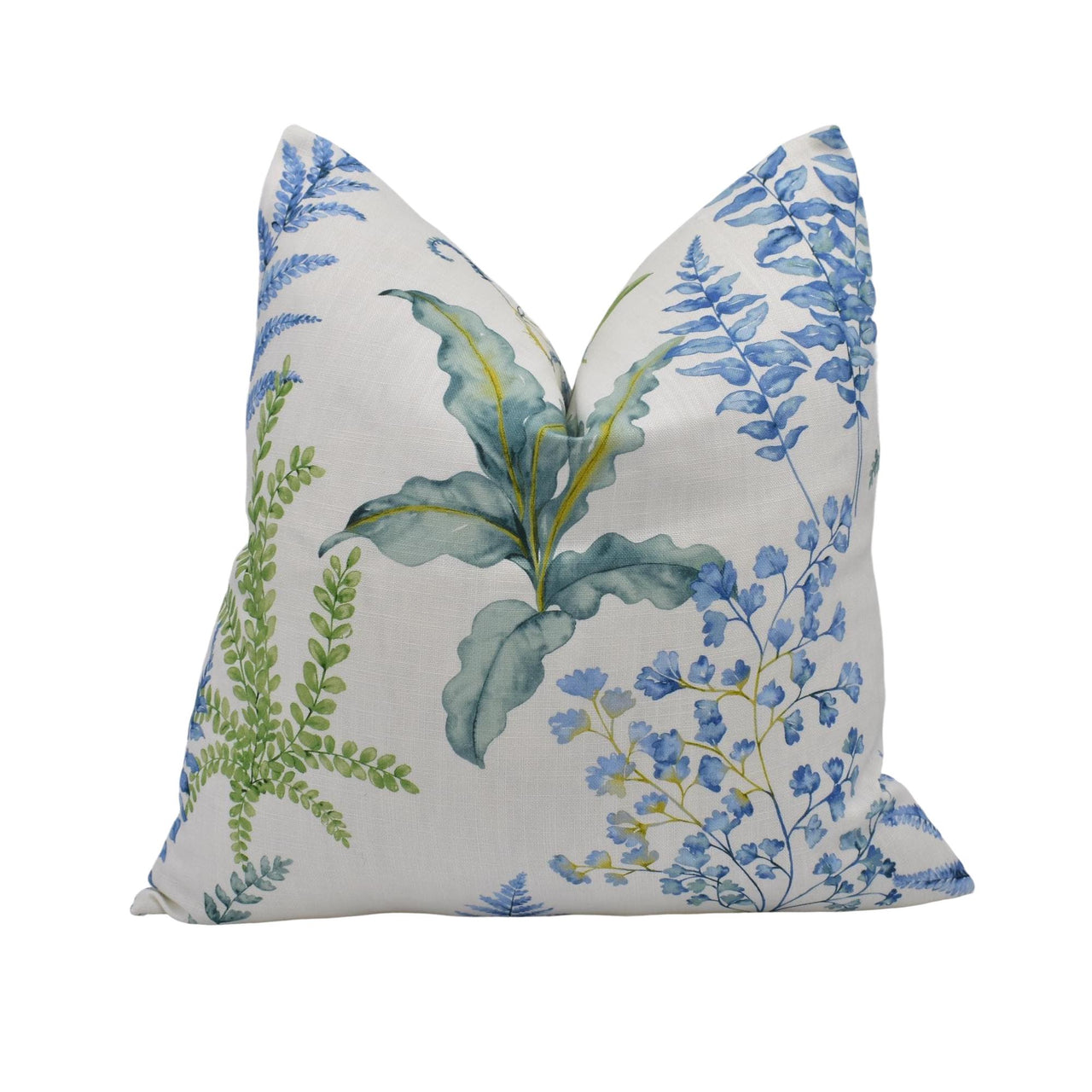 a white pillow with blue and green flowers on it