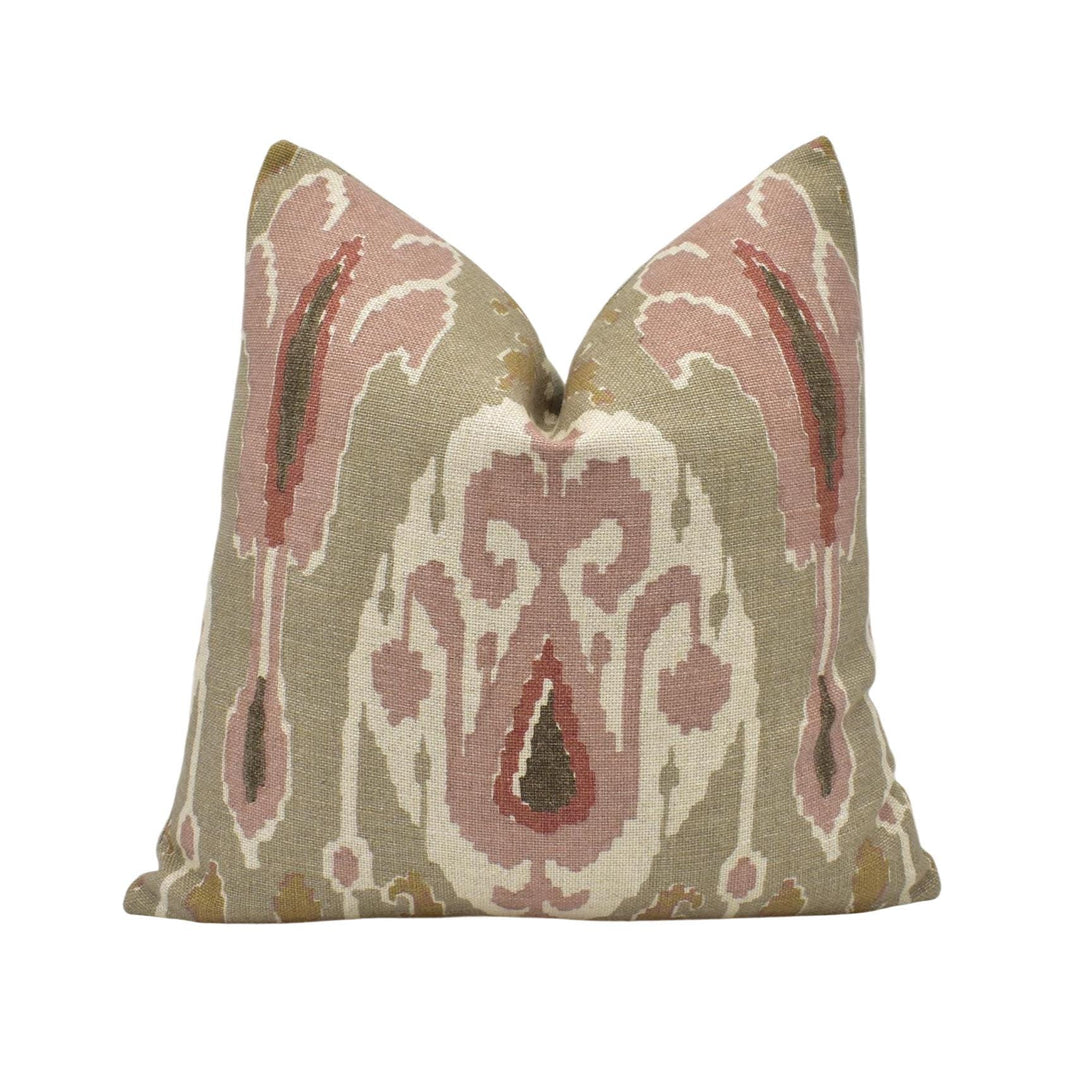 a pillow with a pink and green design on it