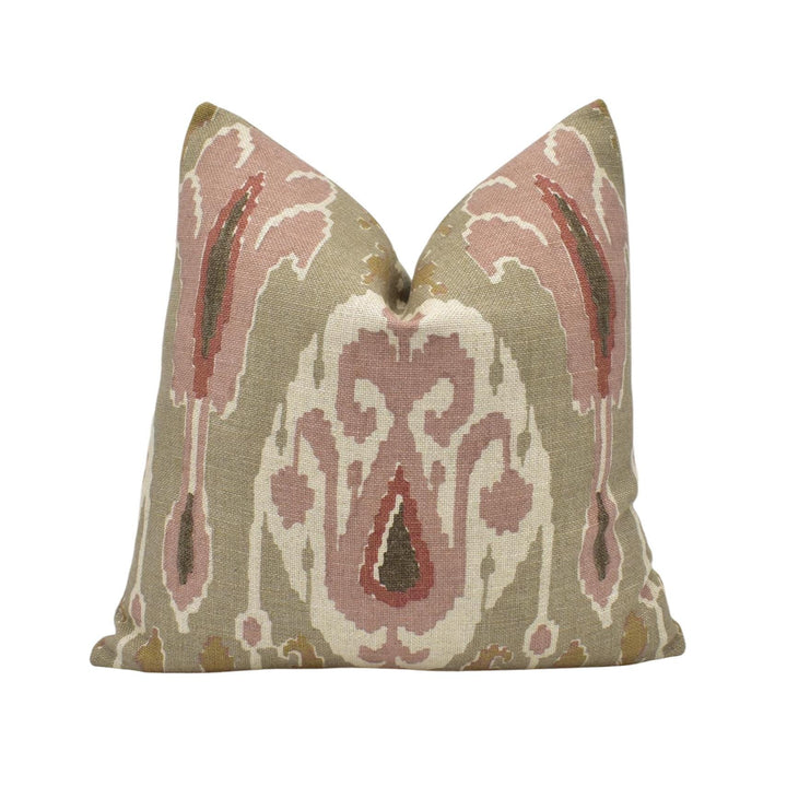 a pillow with a pink and green design on it