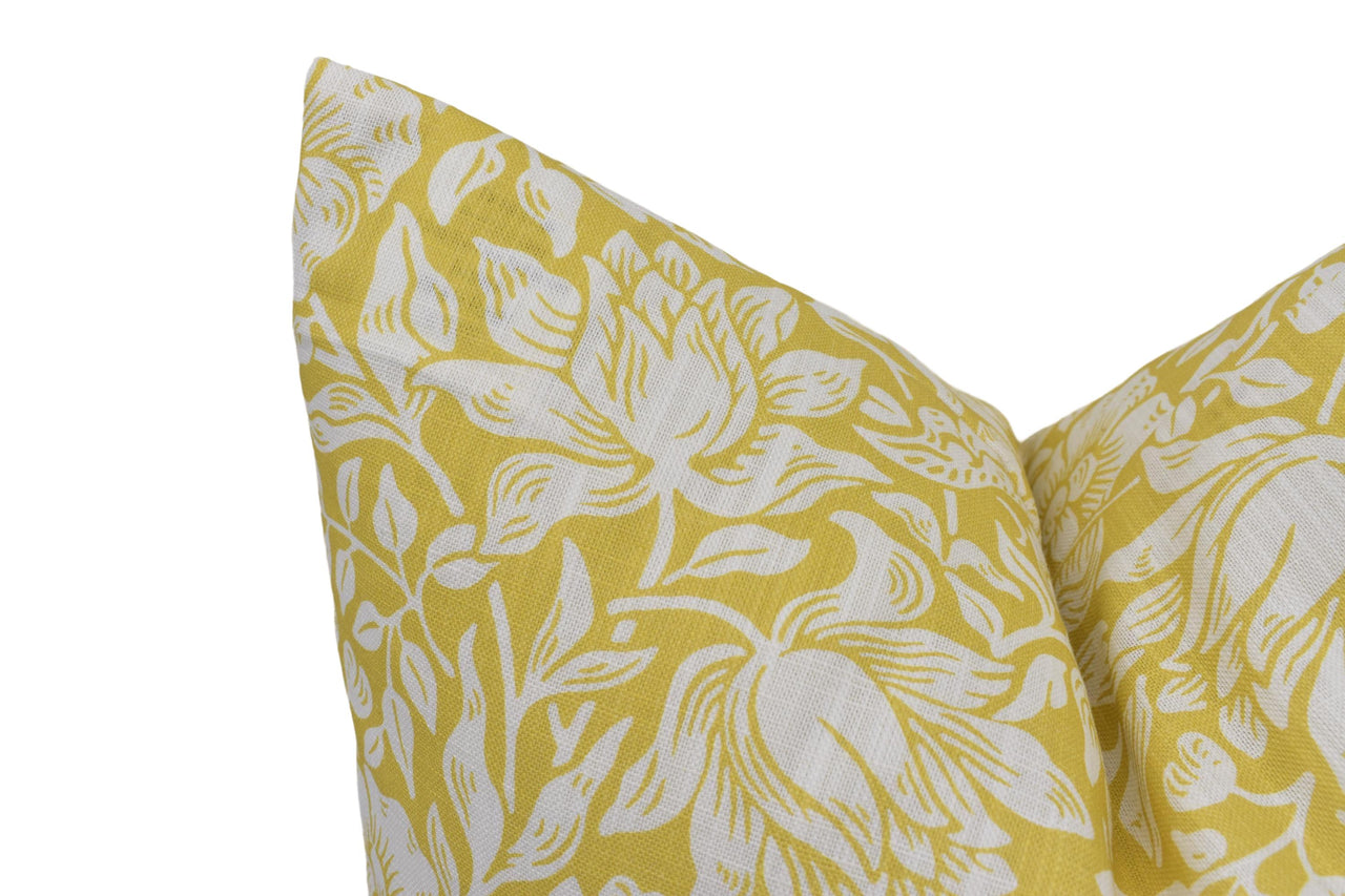 a close up of a yellow and white pillow