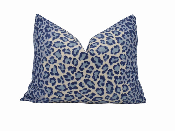 a blue and white leopard print pillow on a white background