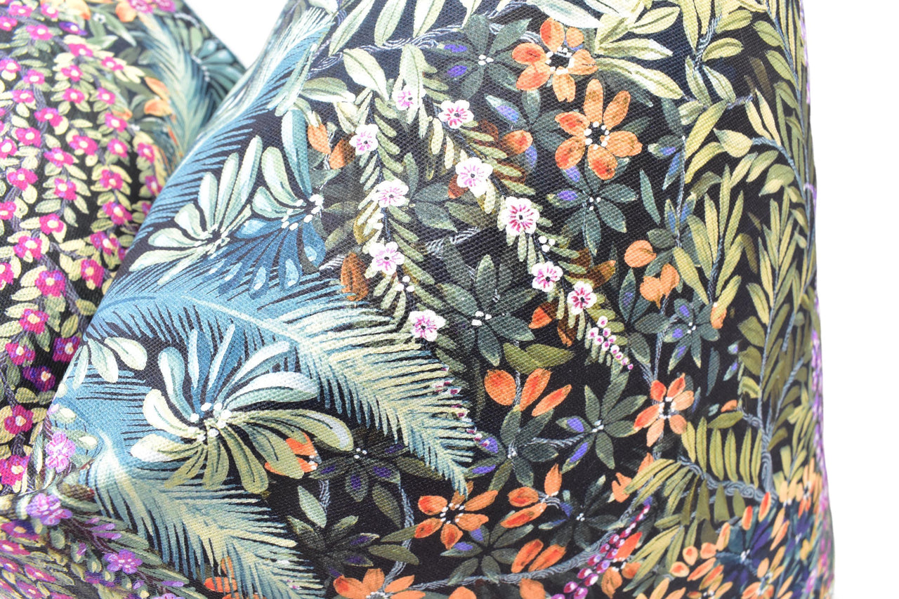 a close up of a pillow with a floral pattern