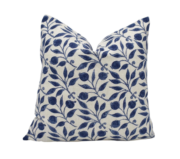 a blue and white pillow on a white background