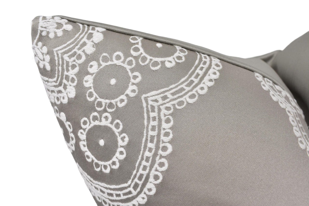 a close up of a gray and white pillow