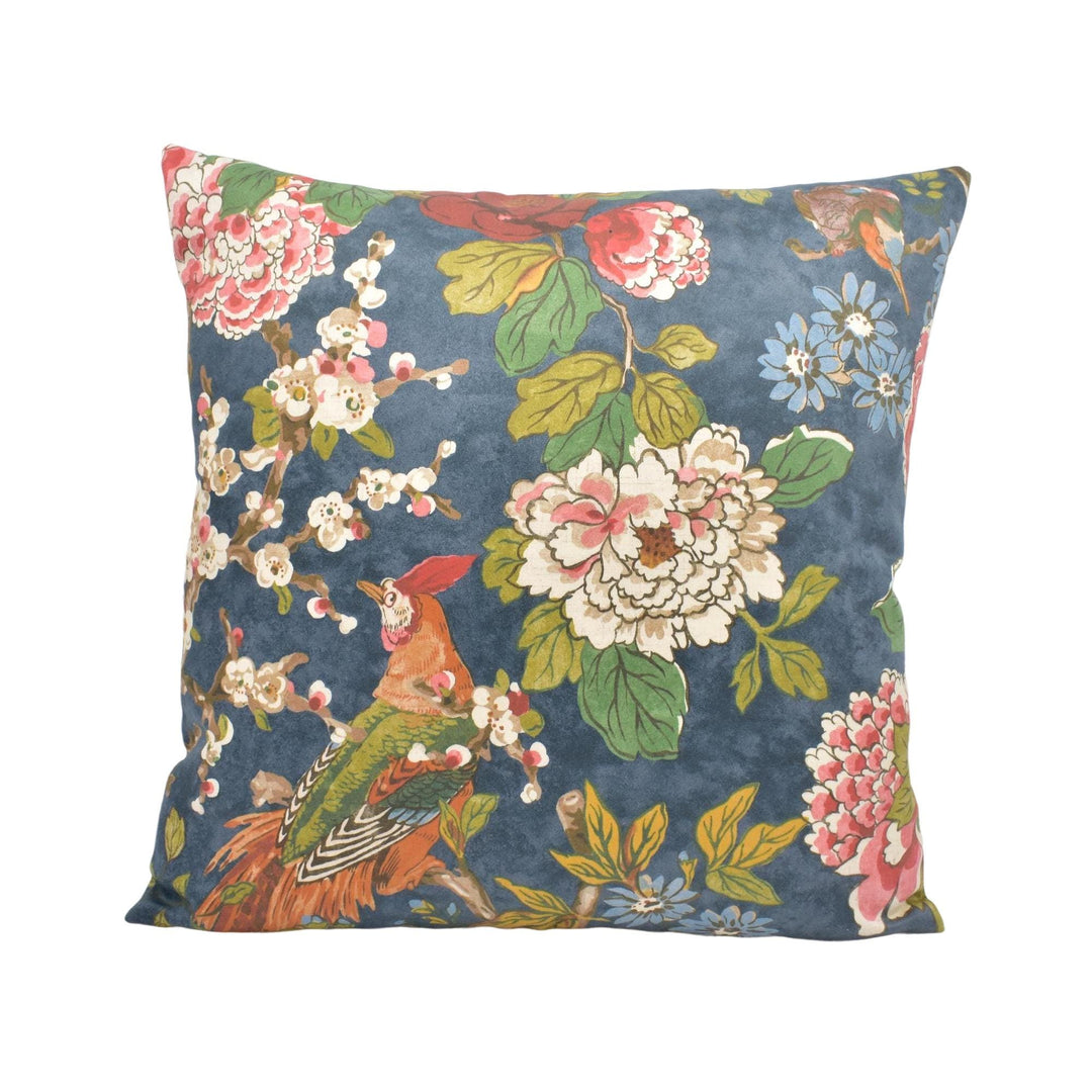 a blue floral pillow with a bird on it