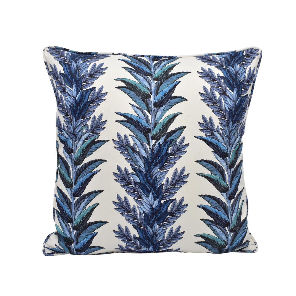 a blue and white pillow with blue leaves on it