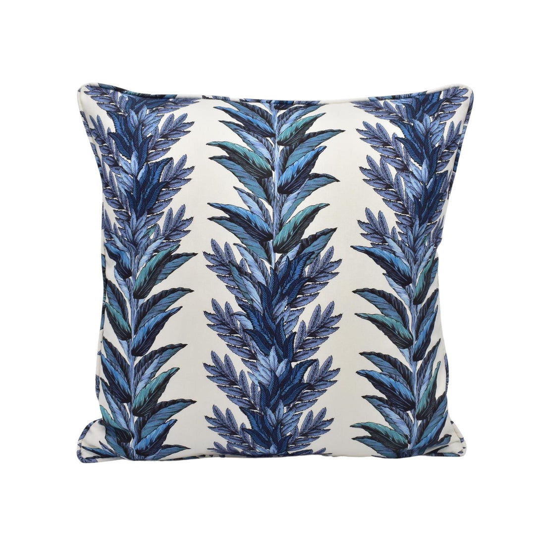 a blue and white pillow with blue leaves on it