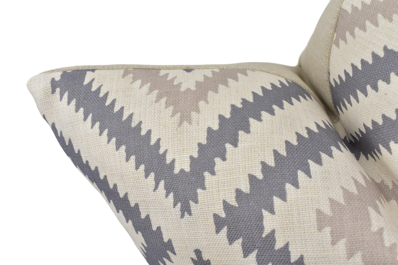 a close up of a gray and white pillow