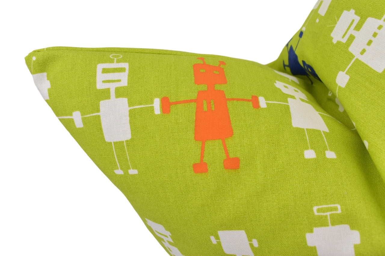 a green pillow with an orange robot on it