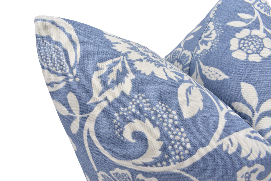 a close up of a blue and white pillow