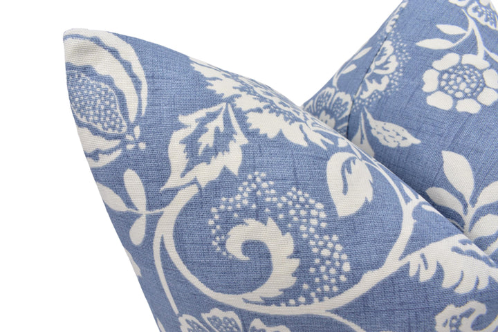a close up of a blue and white pillow