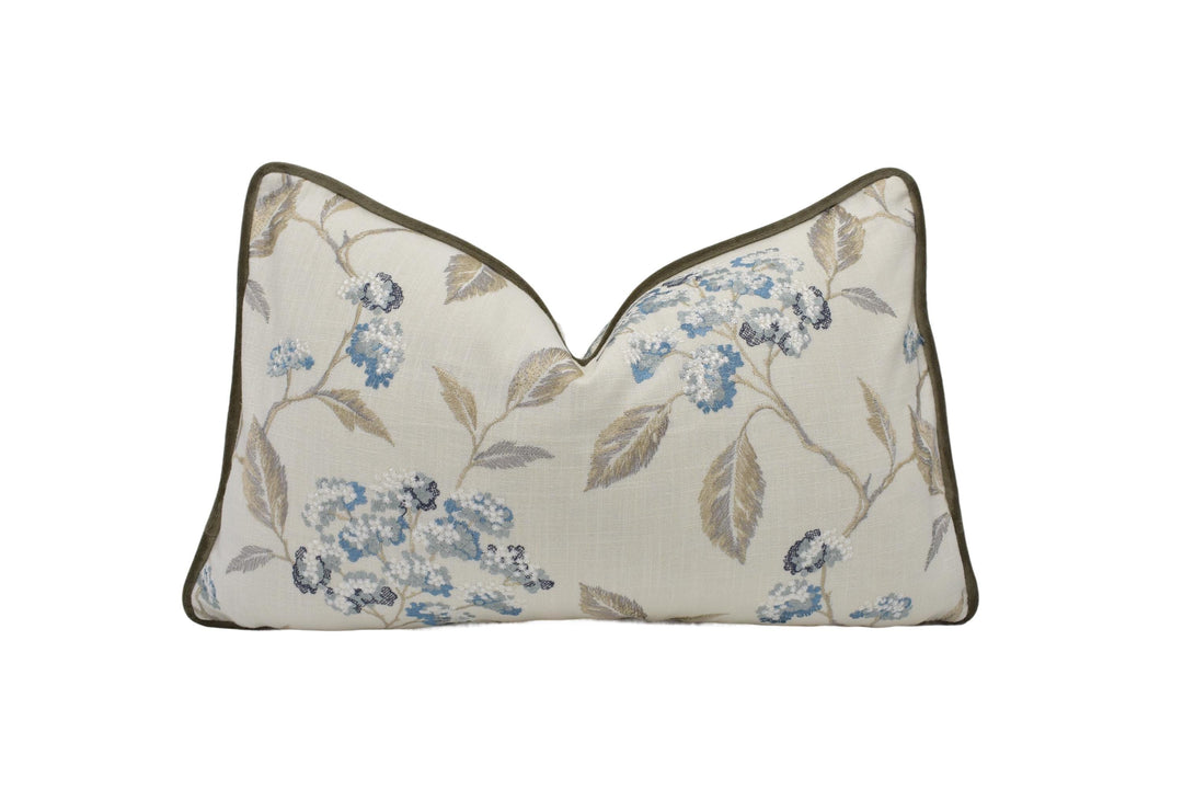 a white pillow with blue flowers on it