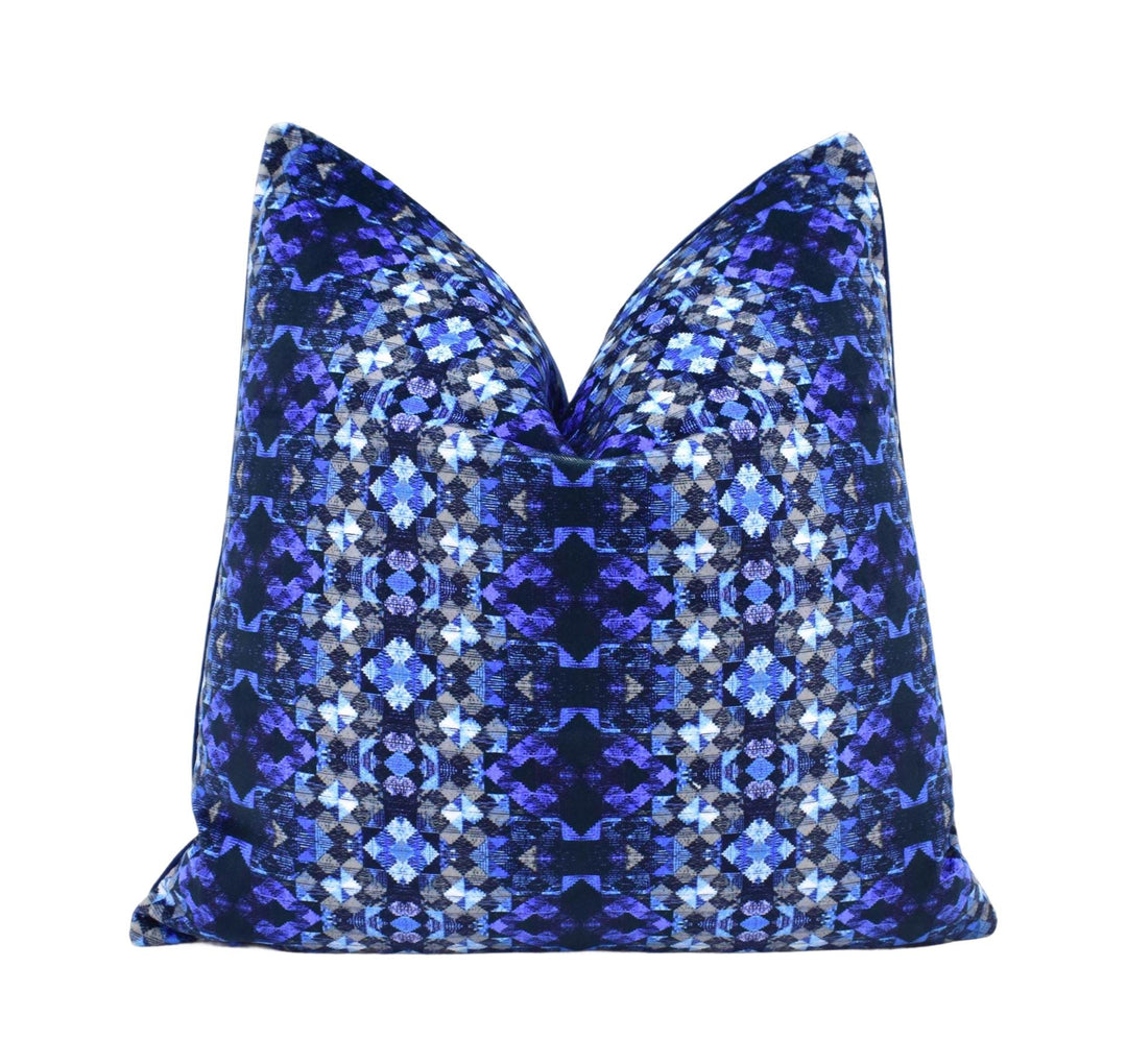 a blue and black pillow on a white background