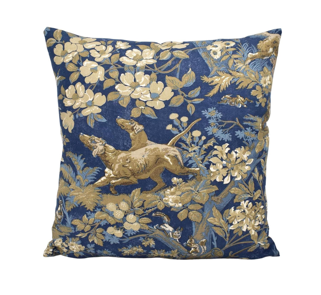 a decorative pillow with a floral pattern in shades of blue and gold.
